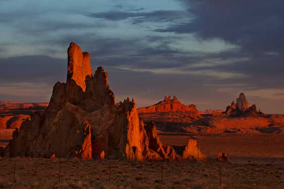 Church Rock in the high desert at sunrise on the Navajo Nation (at distant right is Agathla Peak)