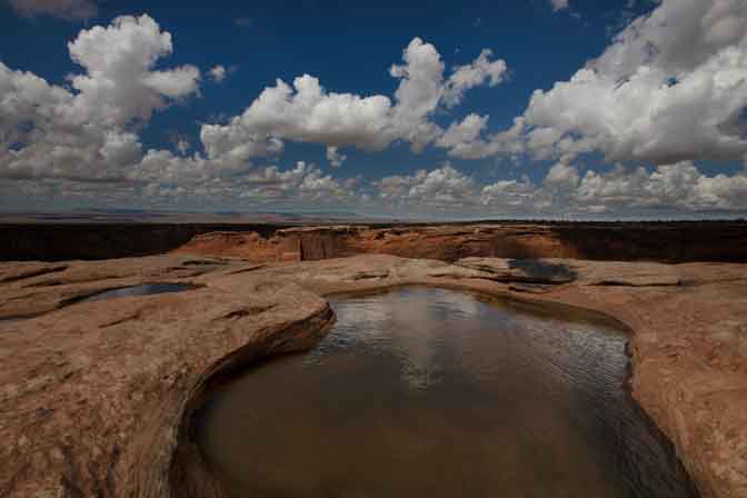 Puddles in sandstone along the south rim of Canyon de Chelly in northern Arizona.