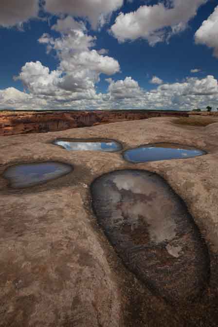 Puddles in sandstone along the south rim of Canyon de Chelly in northern Arizona